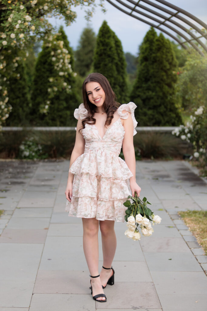 Raleigh Senior Photographs in a Garden holding roses