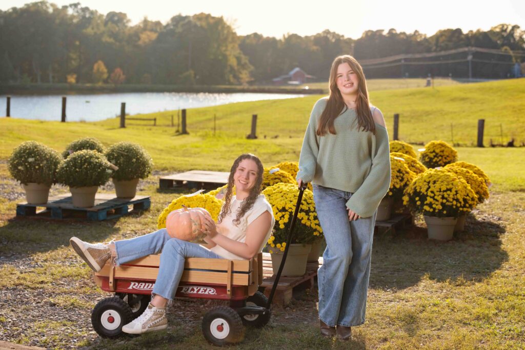 Raleigh Senior Pumpkin Patch Fall Portraits having fun in the cart